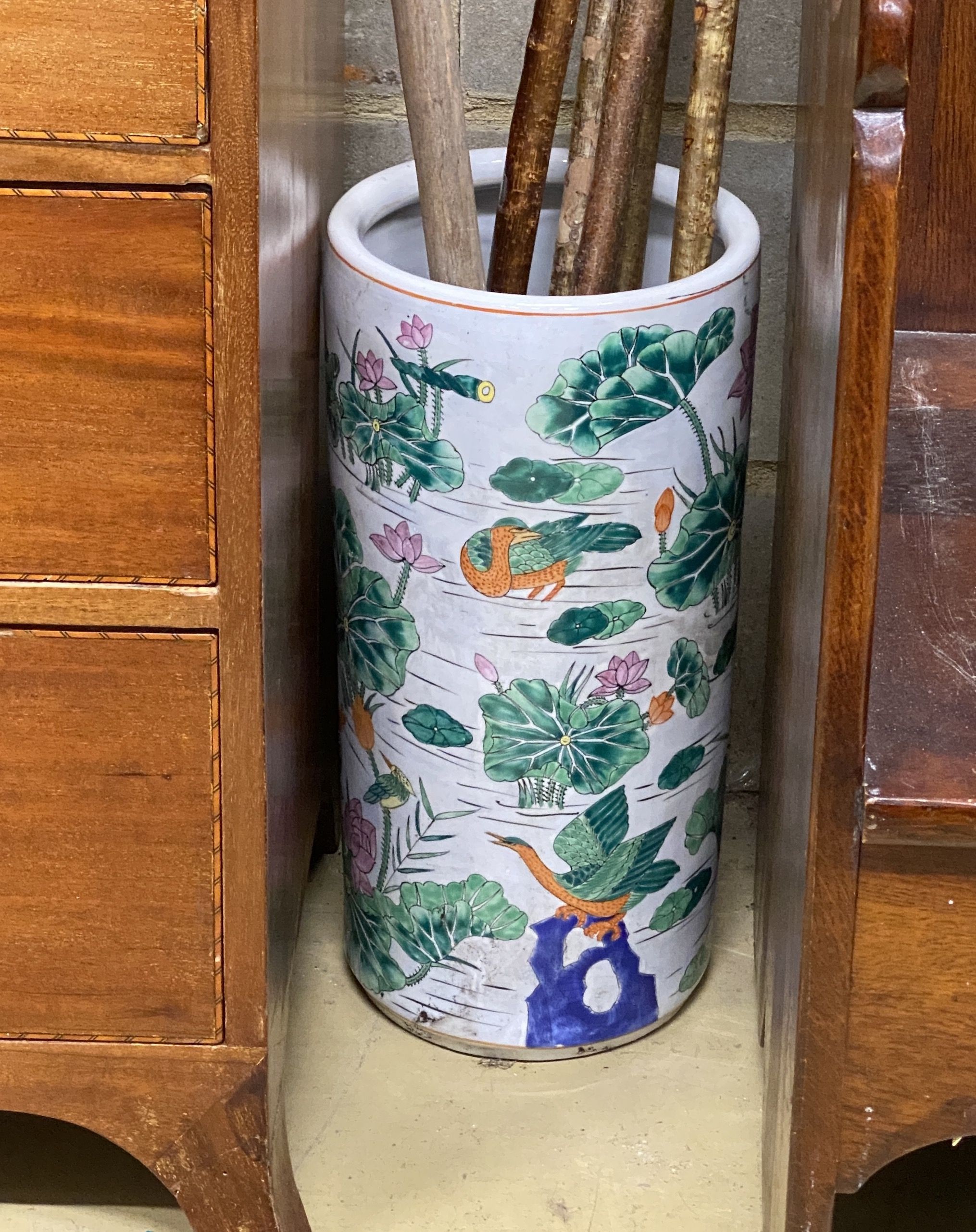 Four assorted walking sticks and canes, a primitive wood rake and a Chinese stick stand